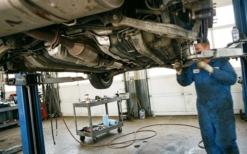 Catalytic converter under a car on a lift, natural light