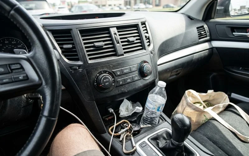 Dashboard A/C controls close-up with vents, everyday car interior