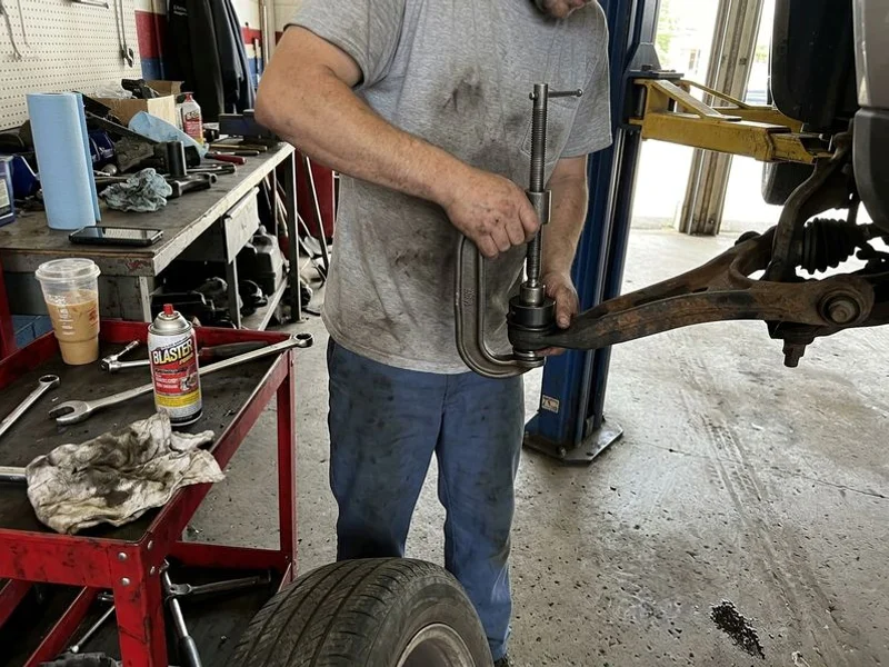 Ball joint being pressed into a control arm