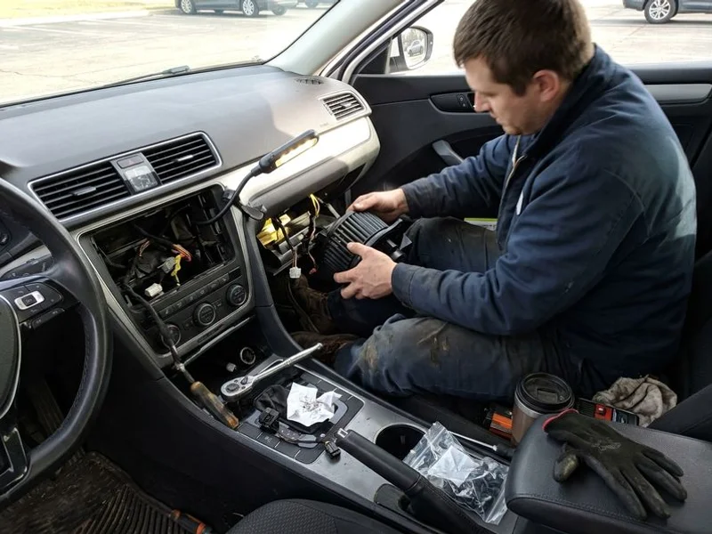 Heater blower motor being installed under the dashboard