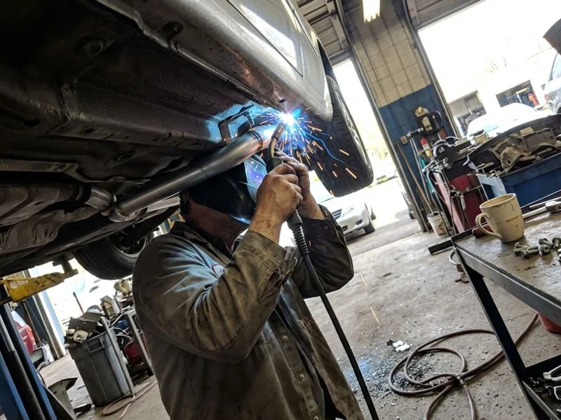 New aluminized exhaust pipe being welded into place