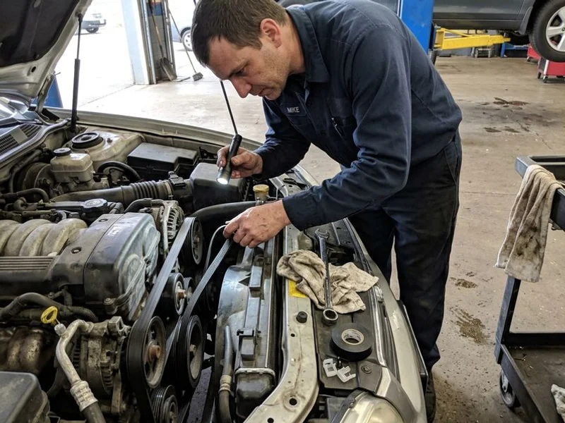 Serpentine belt being inspected for wear