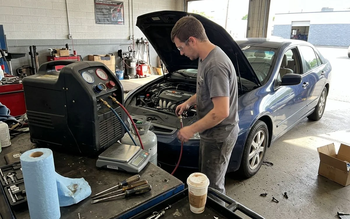 Refrigerant recovery machine recharging a car A/C system on a digital scale